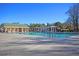 This community pool features lane lines, a pergola with lounge chairs, and an adjacent recreation building at 9670 Pebble Creek Blvd, Summerville, SC 29485
