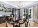Elegant dining room with a large wooden table, bar area, and natural light at 9670 Pebble Creek Blvd, Summerville, SC 29485