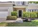Close-up of front door with landscaping, address, and well-maintained lawn at 9670 Pebble Creek Blvd, Summerville, SC 29485