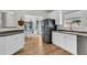 Open kitchen with stainless steel refrigerator, white cabinets, and a breakfast nook at 9670 Pebble Creek Blvd, Summerville, SC 29485