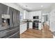 Bright kitchen features stainless steel appliances, white cabinetry, and an adjacent dining area at 9670 Pebble Creek Blvd, Summerville, SC 29485