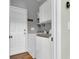 This laundry room has a door to the outside, newer appliances, and storage cabinets and shelves at 9670 Pebble Creek Blvd, Summerville, SC 29485
