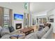 Bright living room with high ceilings, fireplace, large windows, and modern decor at 9670 Pebble Creek Blvd, Summerville, SC 29485