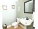 Stylish powder room with a pedestal sink, decorative mirror, and neutral paint at 100 N Gateshead Xing, Goose Creek, SC 29445