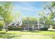 Charming brick home featuring a manicured lawn, mature trees, and a welcoming front porch with gazebo at 100 N Gateshead Xing, Goose Creek, SC 29445