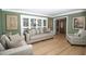 Cozy living room featuring neutral furniture, wood floors, and natural light at 100 N Gateshead Xing, Goose Creek, SC 29445