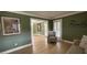Comfortable chair in a bright living room that connects to an open hallway and front porch at 100 N Gateshead Xing, Goose Creek, SC 29445