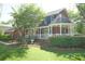 Side view of brick house with well maintained lawn and landscape and cozy outdoor patio at 100 N Gateshead Xing, Goose Creek, SC 29445