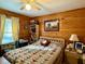 Cozy bedroom featuring warm wood paneling, comfortable bed, and natural light from the window at 1020 Welles Ln, Walterboro, SC 29488