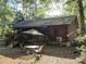 Log cabin-style home with screened porch and outdoor seating area at 1020 Welles Ln, Walterboro, SC 29488