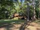 Charming log cabin nestled among mature trees and open lawn, providing a tranquil and private setting at 1020 Welles Ln, Walterboro, SC 29488