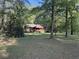 Picturesque log cabin surrounded by lush trees, offering a serene setting and a spacious, well-maintained lawn at 1020 Welles Ln, Walterboro, SC 29488