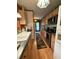 Functional kitchen with stainless steel appliances, light wood cabinets, and an elongated layout leading to an exterior door at 1020 Welles Ln, Walterboro, SC 29488