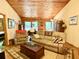 Cozy living room showcasing a comfortable seating area with wood paneling and ceilings for a rustic charm at 1020 Welles Ln, Walterboro, SC 29488
