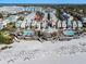 Beautiful aerial view of the community with two pools, beachfront access, and colorful beach homes at 103 Grand Pavilion Blvd, Isle of Palms, SC 29451