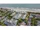 Aerial view of coastal community with charming beach homes, lush trees, and private beach access at 103 Grand Pavilion Blvd, Isle of Palms, SC 29451
