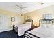 Bright bedroom features two twin beds with iron frames, neutral walls, and a ceiling fan for comfort at 103 Grand Pavilion Blvd, Isle of Palms, SC 29451