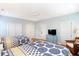 Bedroom with two beds, ceiling fan, hardwood floors, doors, and a cozy armchair at 103 Grand Pavilion Blvd, Isle of Palms, SC 29451