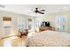 Bright bedroom with a ceiling fan, wood floors, and access to a balcony with plantation shutters at 103 Grand Pavilion Blvd, Isle of Palms, SC 29451