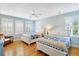 Bedroom featuring two beds, a ceiling fan, white shutters, and beautiful hardwood floors at 103 Grand Pavilion Blvd, Isle of Palms, SC 29451