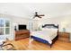 Spacious bedroom featuring a blue bed frame, wooden floors, and plenty of natural light from shuttered windows at 103 Grand Pavilion Blvd, Isle of Palms, SC 29451