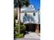 Inviting multi-story beach home featuring a brick-columned facade and breezy, light-filled windows at 103 Grand Pavilion Blvd, Isle of Palms, SC 29451