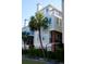 Charming townhouse with a balcony, brick columns and lush, tropical landscaping at 103 Grand Pavilion Blvd, Isle of Palms, SC 29451