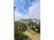 Scenic view of beach houses surrounded by lush palm trees and blue skies, offering a tropical paradise ambiance at 103 Grand Pavilion Blvd, Isle of Palms, SC 29451