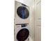 Convenient laundry room with stacked washer and dryer units, maximizing space in a compact design at 103 Grand Pavilion Blvd, Isle of Palms, SC 29451