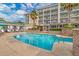 Beautiful community pool with clear blue water, inviting seating, and lush landscaping at 103 Grand Pavilion Blvd, Isle of Palms, SC 29451