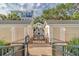 Gated walkway leading to beach access flanked by beach storage units with stairs and lush landscaping at 103 Grand Pavilion Blvd, Isle of Palms, SC 29451