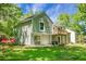 Backyard view of home with deck, patio, well-maintained lawn and flowering trees at 105 Brailsford Rd, Summerville, SC 29485