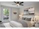 Serene bedroom featuring a ceiling fan, a large window, and neutral decor at 105 Brailsford Rd, Summerville, SC 29485