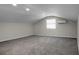 Carpeted bonus room with sloped ceiling and dormer window provides flexible living space at 105 Brailsford Rd, Summerville, SC 29485