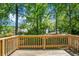 View from wooden deck shows a lush, green backyard with mature trees and neighboring homes at 105 Brailsford Rd, Summerville, SC 29485