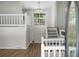 Bright entryway featuring white railings, hardwood floors, and a clear view of the staircase at 105 Brailsford Rd, Summerville, SC 29485