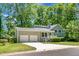 Inviting two-story home with attached garage, showcasing a well-maintained lawn and lush greenery at 105 Brailsford Rd, Summerville, SC 29485