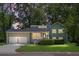 Charming two-story home with attached two-car garage and manicured lawn under a twilight sky at 105 Brailsford Rd, Summerville, SC 29485