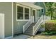 Charming front entrance boasts stairs leading to door with white railing and well-maintained landscaping at 105 Brailsford Rd, Summerville, SC 29485