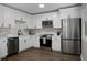 Bright kitchen features white cabinets, stainless steel appliances, and wood-look flooring at 105 Brailsford Rd, Summerville, SC 29485