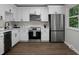 Bright kitchen features white cabinets, stainless steel appliances, and wood-look flooring at 105 Brailsford Rd, Summerville, SC 29485