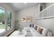 Bright living room with a vaulted ceiling, large windows, and a comfortable white sofa at 105 Brailsford Rd, Summerville, SC 29485