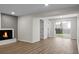 Inviting living room with hardwood floors, modern fireplace, and sliding glass door leading to the backyard at 105 Brailsford Rd, Summerville, SC 29485