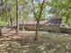 Enjoy the great outdoors in this backyard featuring mature trees, a brick home, and a fenced perimeter for privacy at 106 Spring Farm Pl, Summerville, SC 29485