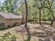 Brick home surrounded by a large backyard with mature trees and a privacy fence providing a peaceful retreat at 106 Spring Farm Pl, Summerville, SC 29485