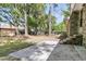 Picture of the home's backyard with a concrete patio, mature trees, an open lawn, and privacy fence at 106 Spring Farm Pl, Summerville, SC 29485