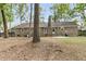 Spacious backyard featuring mature trees, brick home, and privacy fence offering an ideal outdoor retreat at 106 Spring Farm Pl, Summerville, SC 29485