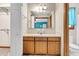 Bathroom with a vanity featuring warm wood cabinetry, a spacious mirror, and an adjoining toilet area at 106 Spring Farm Pl, Summerville, SC 29485