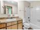 This bathroom offers a tub with white tile surround, classic single sink vanity, and a large mirror at 106 Spring Farm Pl, Summerville, SC 29485