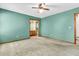 Inviting bedroom with ensuite bathroom, neutral carpet, and soft teal walls, offering a calming retreat at 106 Spring Farm Pl, Summerville, SC 29485